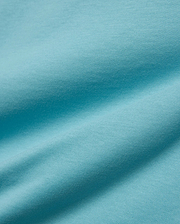 Kids' Alfie Back Graphic Tee in vibrant aqua blue, soft jersey knit fabric with subtle texture and flowing drapes, featuring a back graphic for a stylish, comfortable look. (5)
