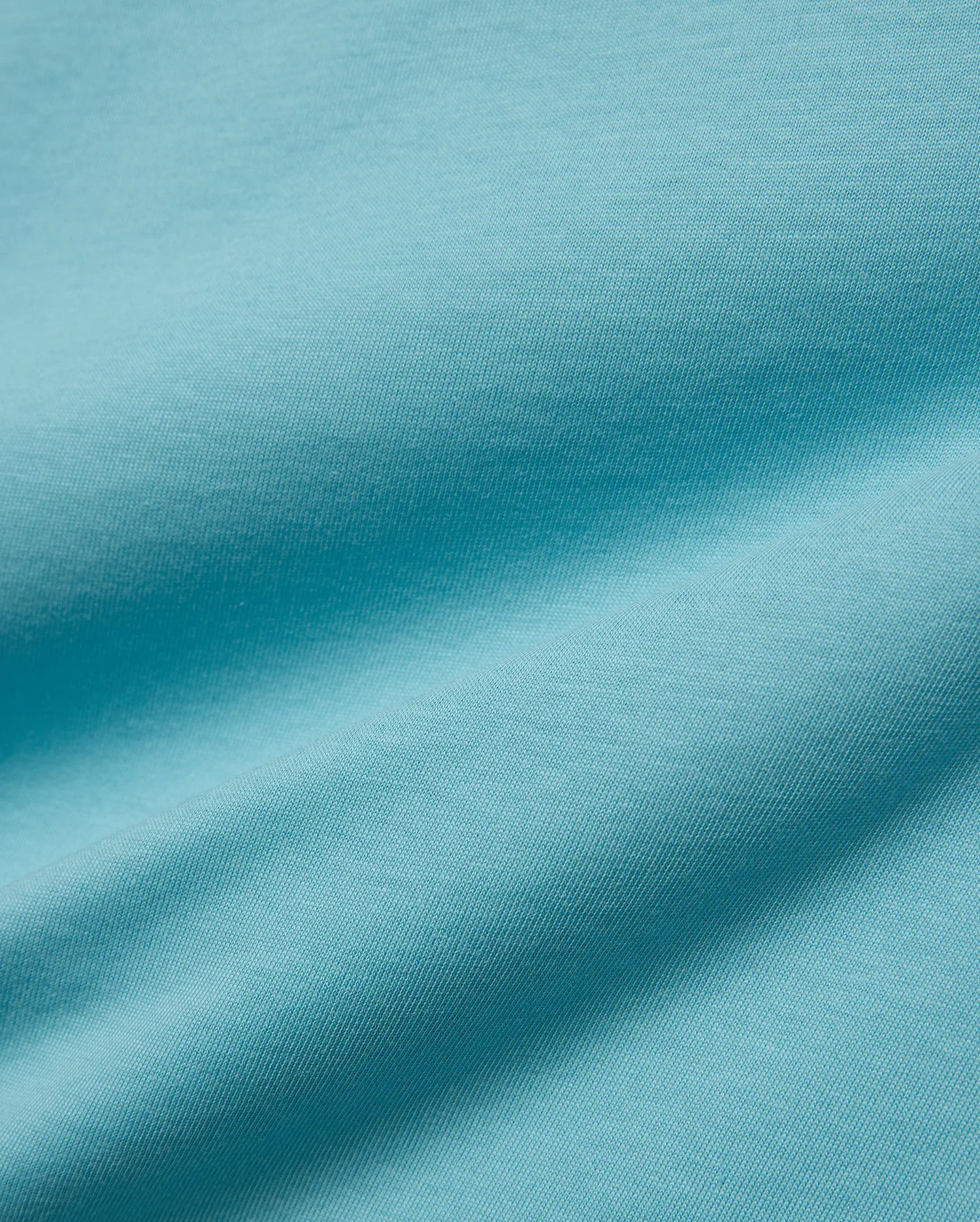 Kids' Alfie Back Graphic Tee in vibrant aqua blue, soft jersey knit fabric with subtle texture and flowing drapes, featuring a back graphic for a stylish, comfortable look. (5)