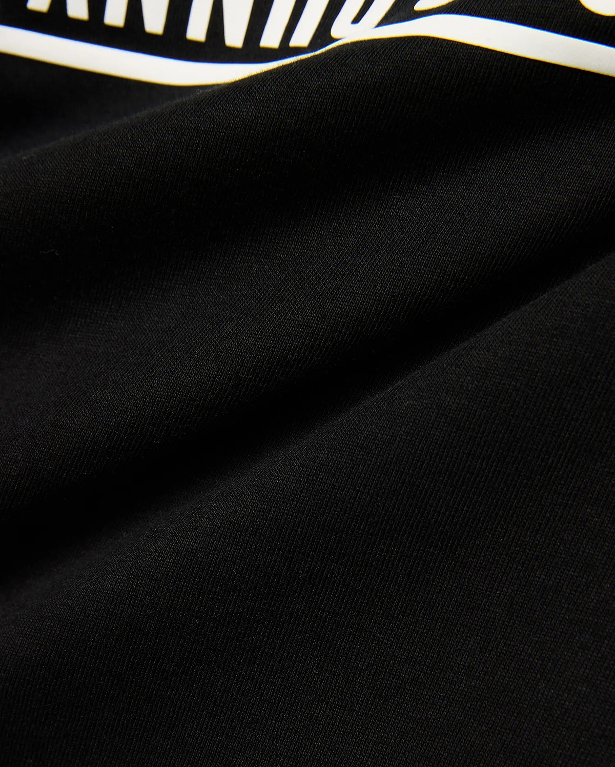 Kids' Raj Pima Graphic Tee, a premium black Pima cotton jersey knit with a soft texture, featuring a prominent, bold white graphic print, embodying refined streetwear style. (6)