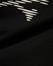 Kids' Slade Pima Graphic Tee, a black Pima cotton jersey t-shirt with a refined streetwear feel, featuring a prominent white embroidered stylized graphic design. (6)