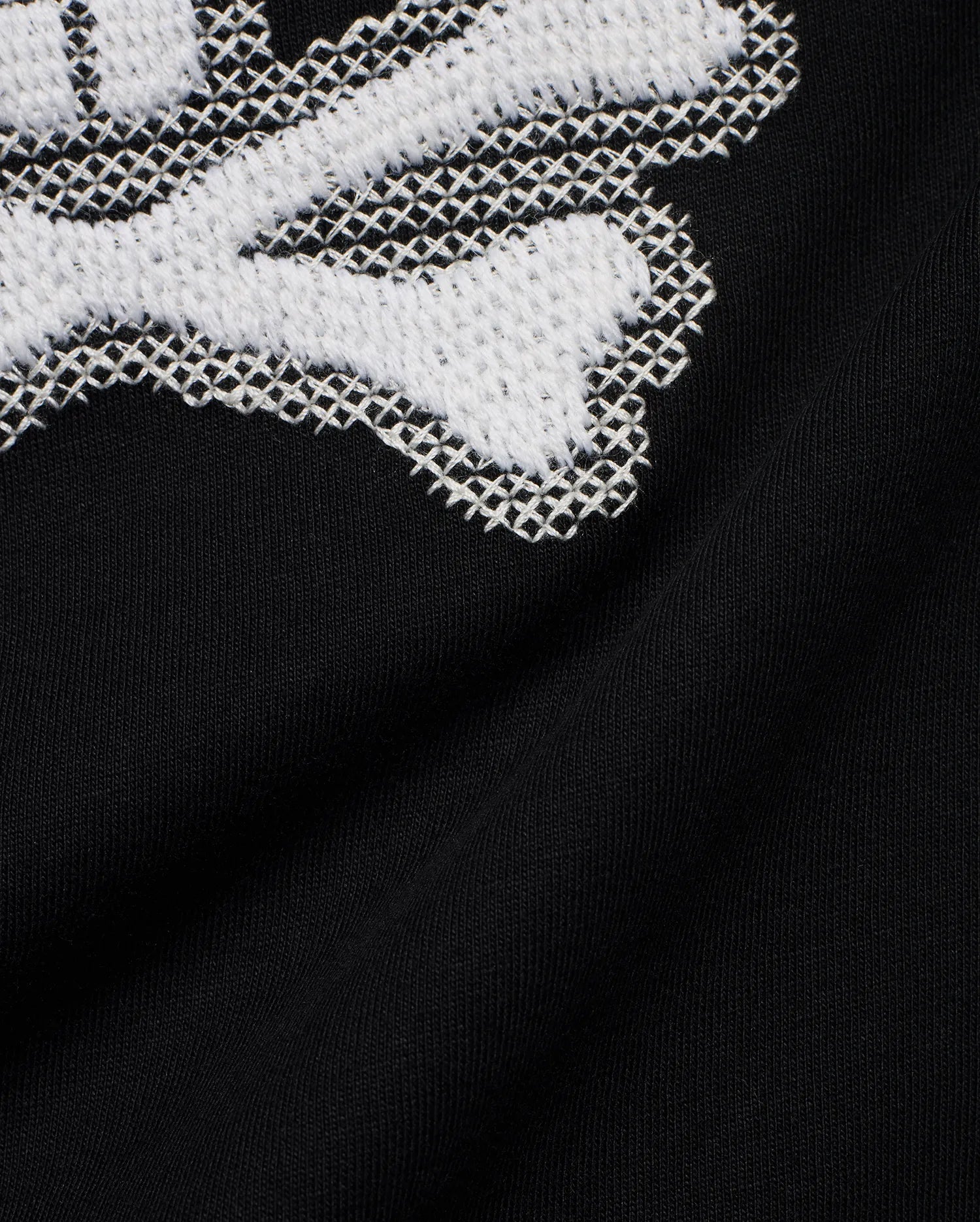 Kids' Samson Pima Graphic Tee in black Pima jersey knit, featuring a large white cross-stitch Psycho Bunny skull graphic. (6)
