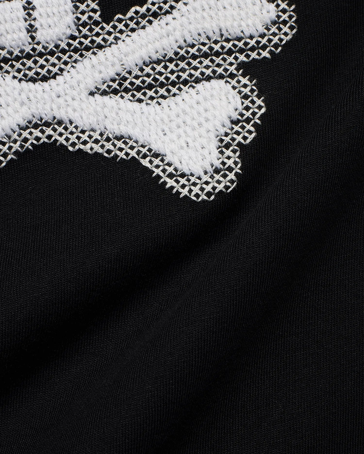 Kids' Samson Pima Graphic Tee in black Pima jersey knit, featuring a large white cross-stitch Psycho Bunny skull graphic. (6)