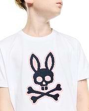 Kids' Samson Pima Graphic Tee. White jersey t-shirt featuring a large, central black and pink cross-stitch Psycho Bunny skull and crossbones logo, classic fit. (3)