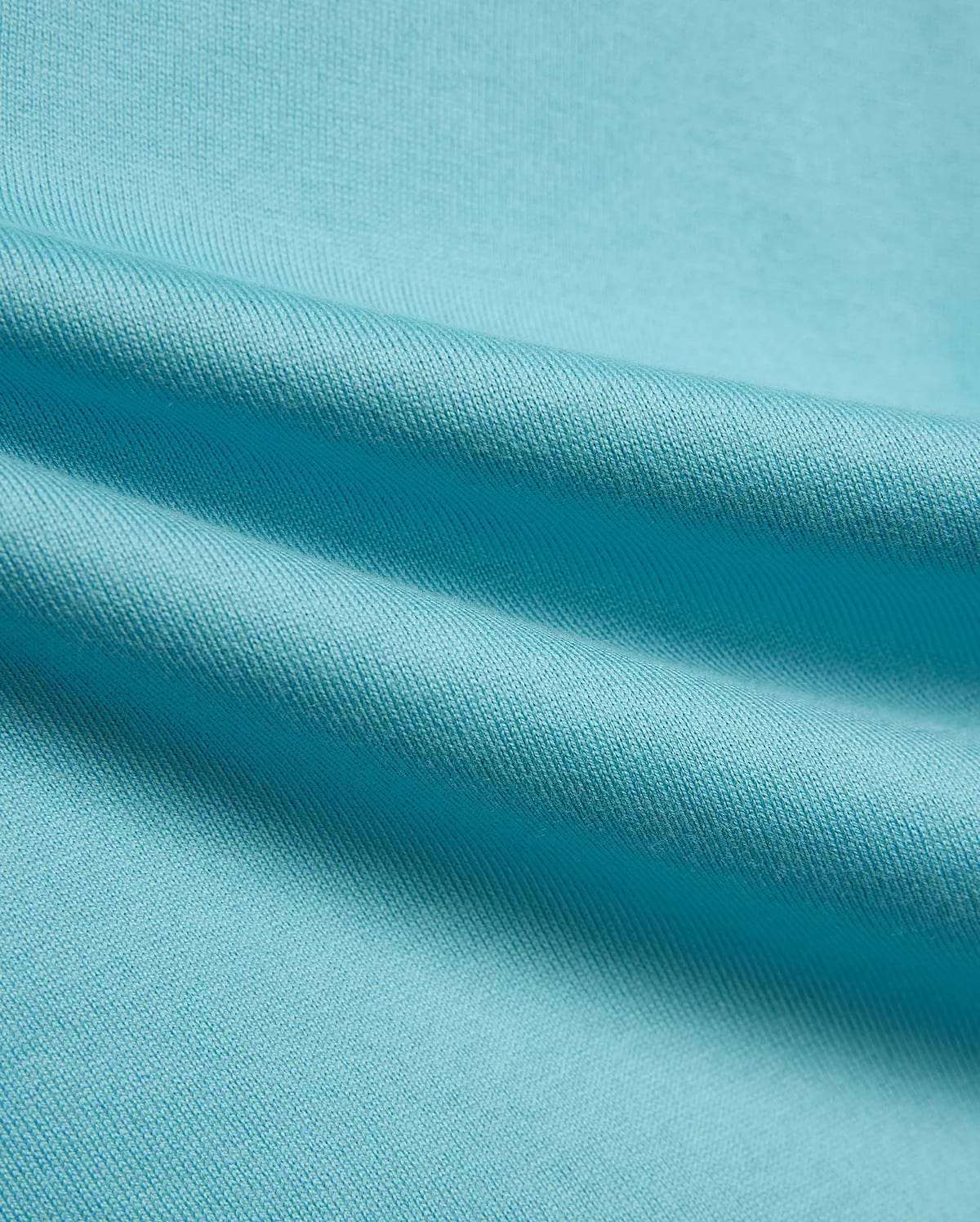 Kid's Norman Longsleeve Oversized Tee in vibrant aqua blue, showcasing its premium, finely woven cotton jersey knit fabric with soft, flowing drapes. (6)