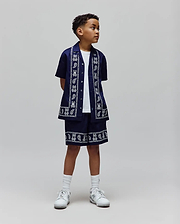 Kids Luke Tencel Border Shirt and matching shorts in navy, featuring a white paisley and repeated Psycho Bunny skull logo border print, crafted from smooth Tencel for a relaxed streetwear fit.