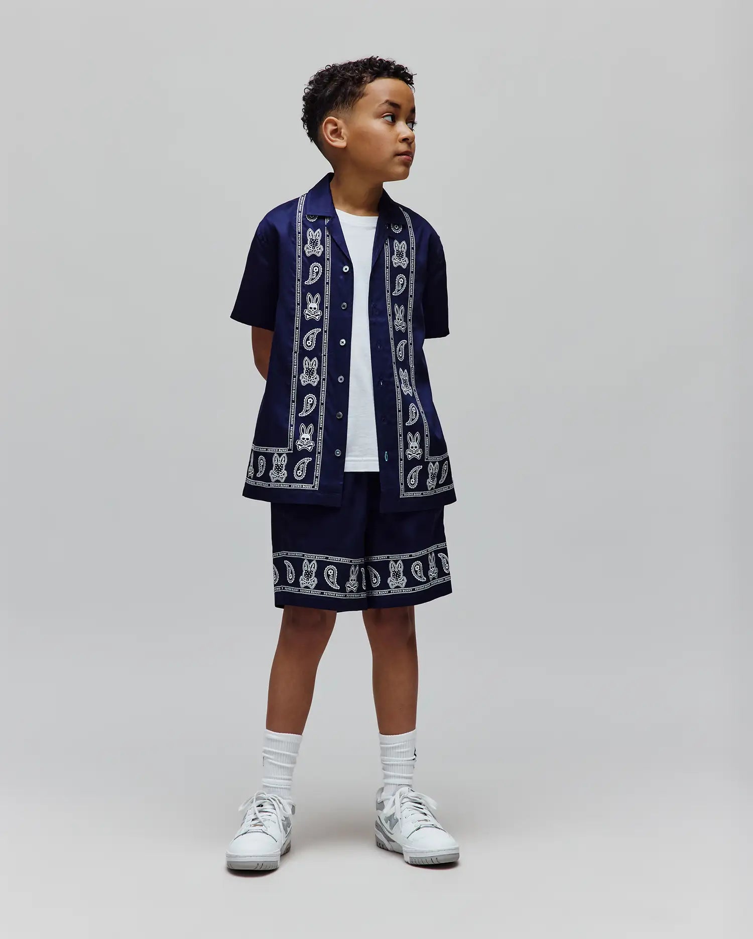 Kids Luke Tencel Border Shirt and matching shorts in navy, featuring a white paisley and repeated Psycho Bunny skull logo border print, crafted from smooth Tencel for a relaxed streetwear fit.