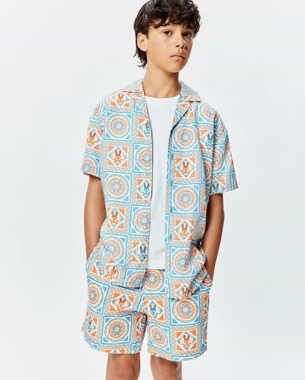 Kids Frank Tencel Shirt and matching shorts, featuring a relaxed fit and an all-over light blue and orange geometric tile print with integrated Psycho Bunny skull logos.