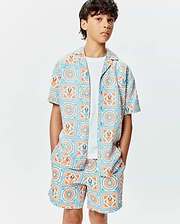 Kids Frank Tencel Shirt and matching shorts, featuring a relaxed fit and an all-over light blue and orange geometric tile print with integrated Psycho Bunny skull logos.