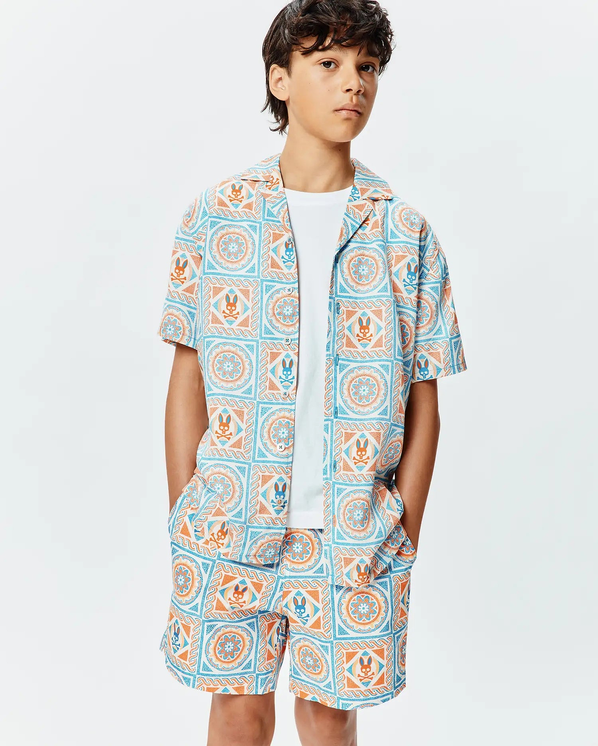 Kids Frank Tencel Shirt and matching shorts, featuring a relaxed fit and an all-over light blue and orange geometric tile print with integrated Psycho Bunny skull logos.