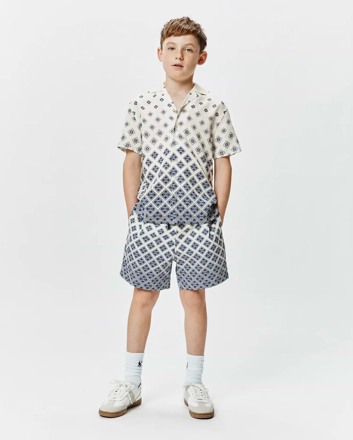 Psycho Bunny Kids Tobias Tencel Shirt and matching shorts, cream with a blue geometric diamond pattern, relaxed fit, featuring a gradient effect on the shirt.