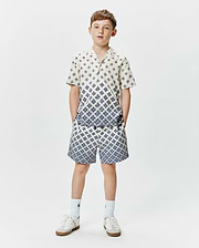 Psycho Bunny Kids Tobias Tencel Shirt and matching shorts, cream with a blue geometric diamond pattern, relaxed fit, featuring a gradient effect on the shirt.