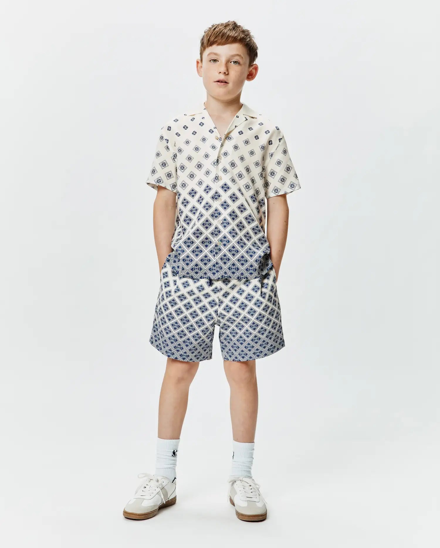 Psycho Bunny Kids Tobias Tencel Shirt and matching shorts, cream with a blue geometric diamond pattern, relaxed fit, featuring a gradient effect on the shirt.