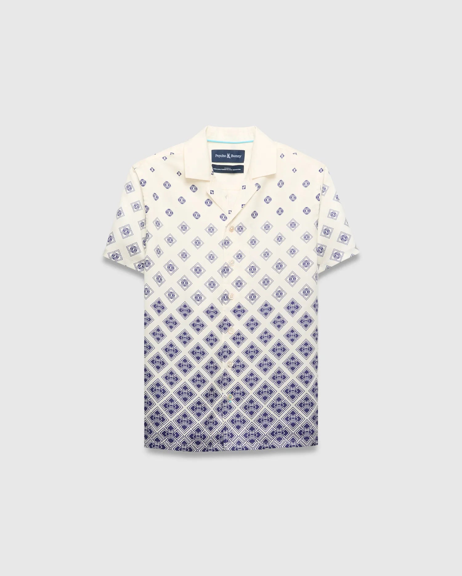 Kids Tobias Tencel Shirt in cream with a navy blue gradient diamond pattern featuring the Psycho Bunny skull logo, a relaxed fit, camp collar, and button-front.