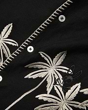 Kids Brad Linen Shirt, black with intricate off-white embroidered palm trees, a small black Psycho Bunny skull logo, and decorative zigzag placket stitching.