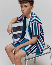 KIDS CLIFF KNIT SHIRT and matching shorts, a relaxed knit set with vibrant multi-color stripes in teal, pink, blue, navy, and white, featuring a small embroidered Psycho Bunny skull logo on the shorts. (2)