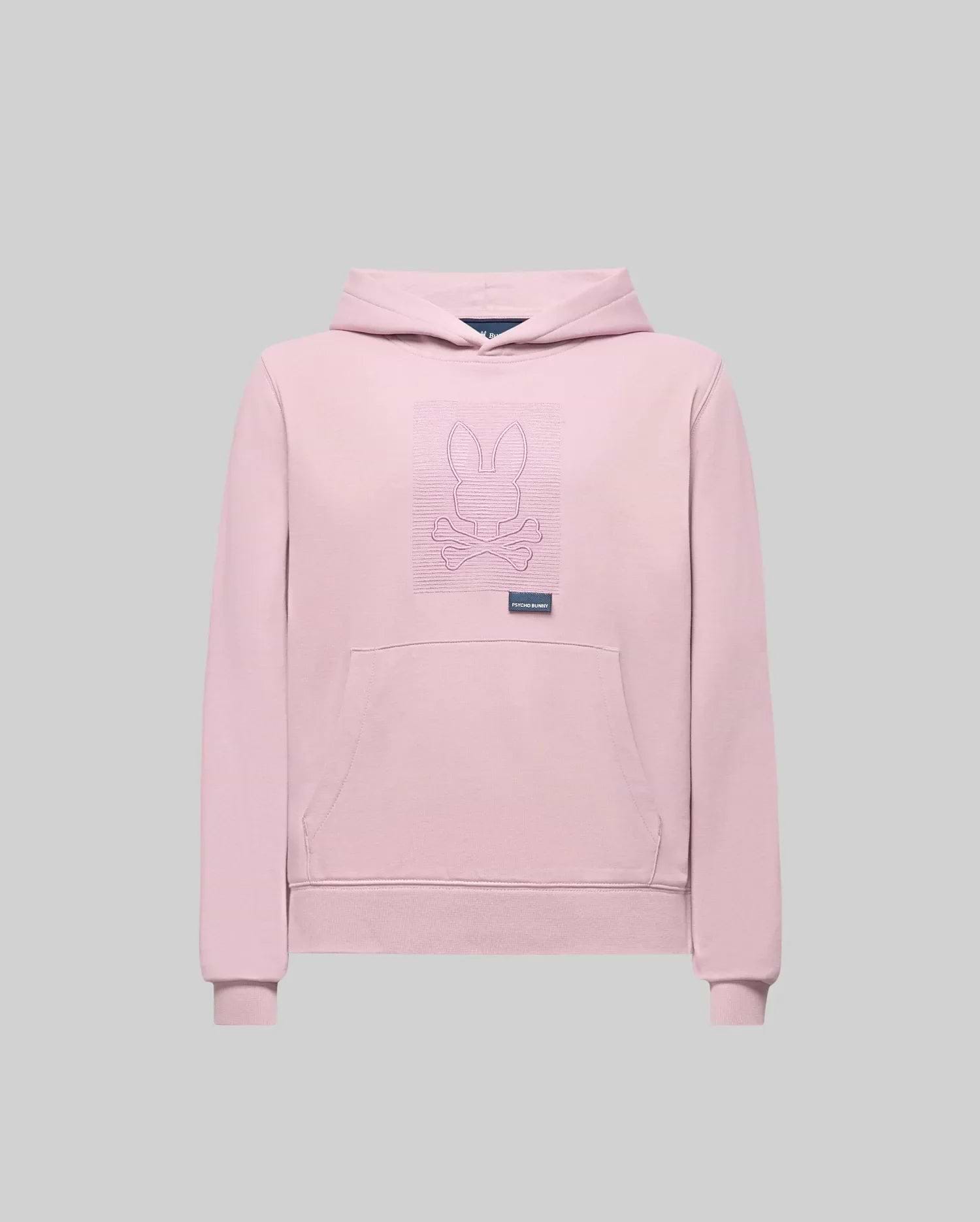 The Psycho Bunny KIDS GRANT HOODIE (KT0500020) is a light pink premium cotton blend with an outlined embroidered Bunny and crossed bones on the chest, front pocket, and small label below the graphic. Displayed on a plain gray background.