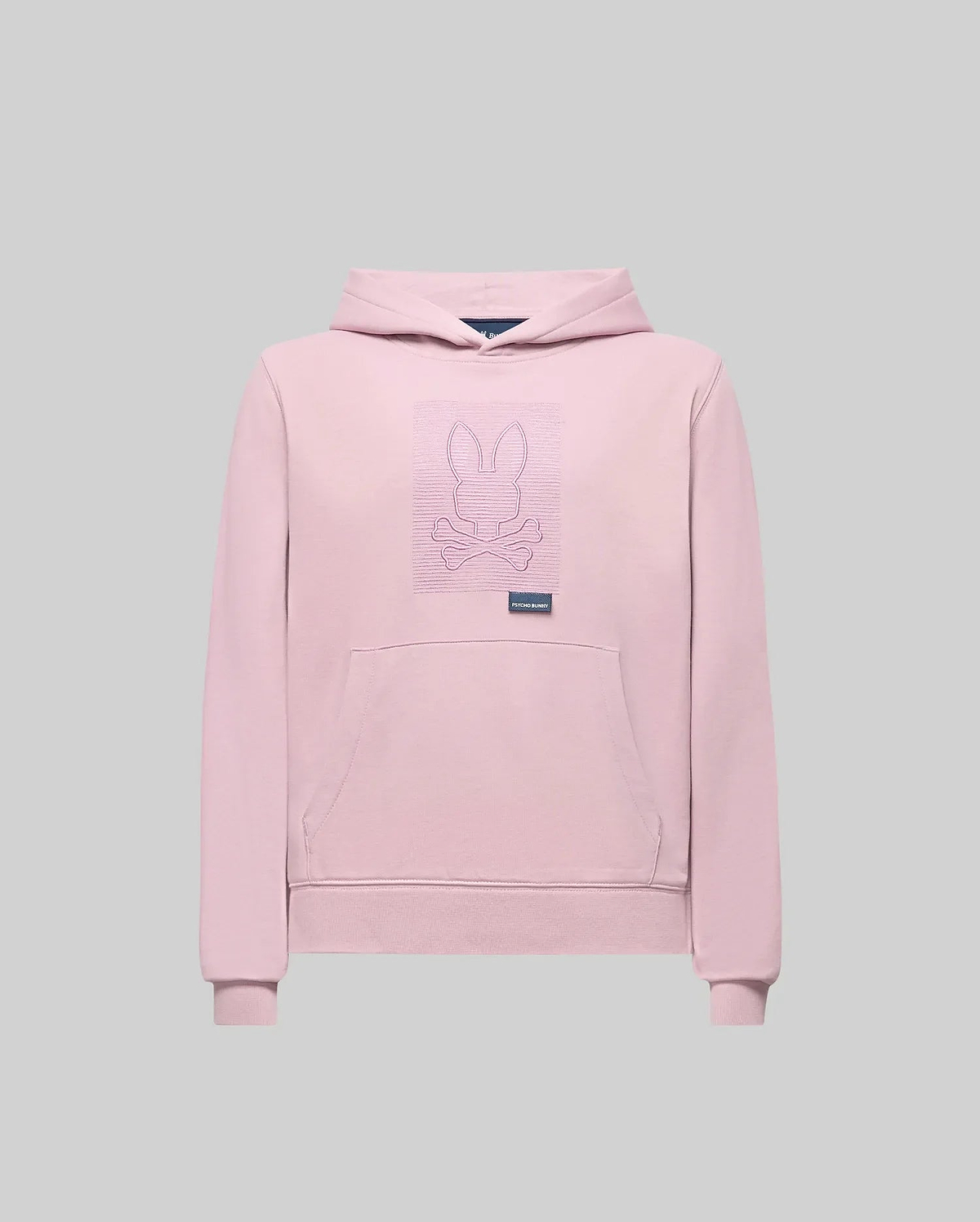 The Psycho Bunny KIDS GRANT HOODIE (KT0500020) is a light pink premium cotton blend with an outlined embroidered Bunny and crossed bones on the chest, front pocket, and small label below the graphic. Displayed on a plain gray background.