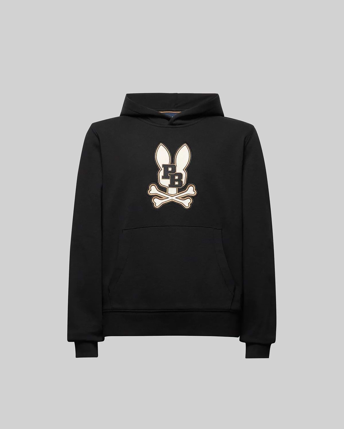 The Psycho Bunny KIDS WADE CORD PATCH HOODIE (KT0500031) is a black athletic hoodie in a premium cotton blend, featuring an embroidered long-eared Bunny patch with "PB" on the chest, shown on a plain gray background.
