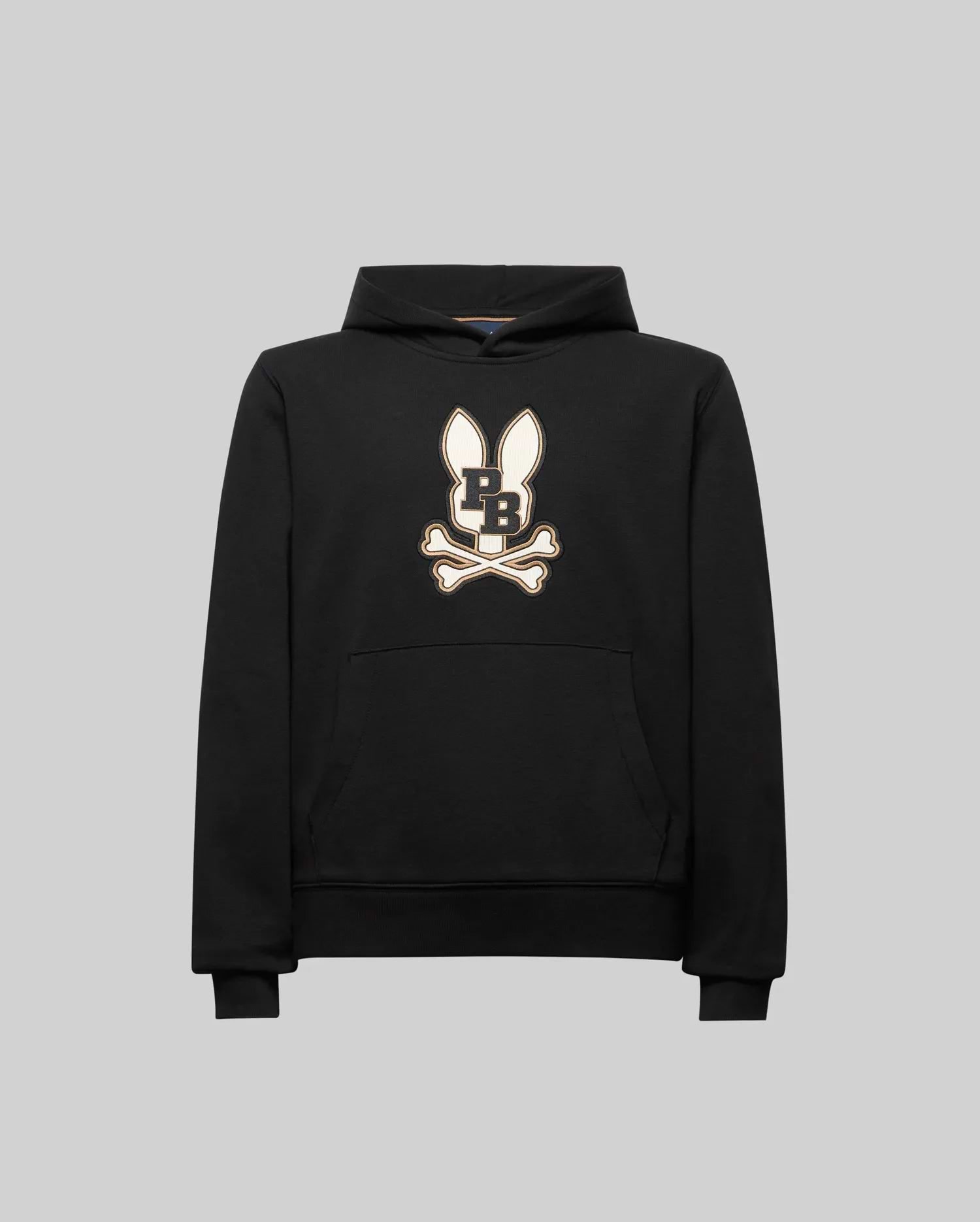The Psycho Bunny KIDS WADE CORD PATCH HOODIE (KT0500031) is a black athletic hoodie in a premium cotton blend, featuring an embroidered long-eared Bunny patch with "PB" on the chest, shown on a plain gray background.