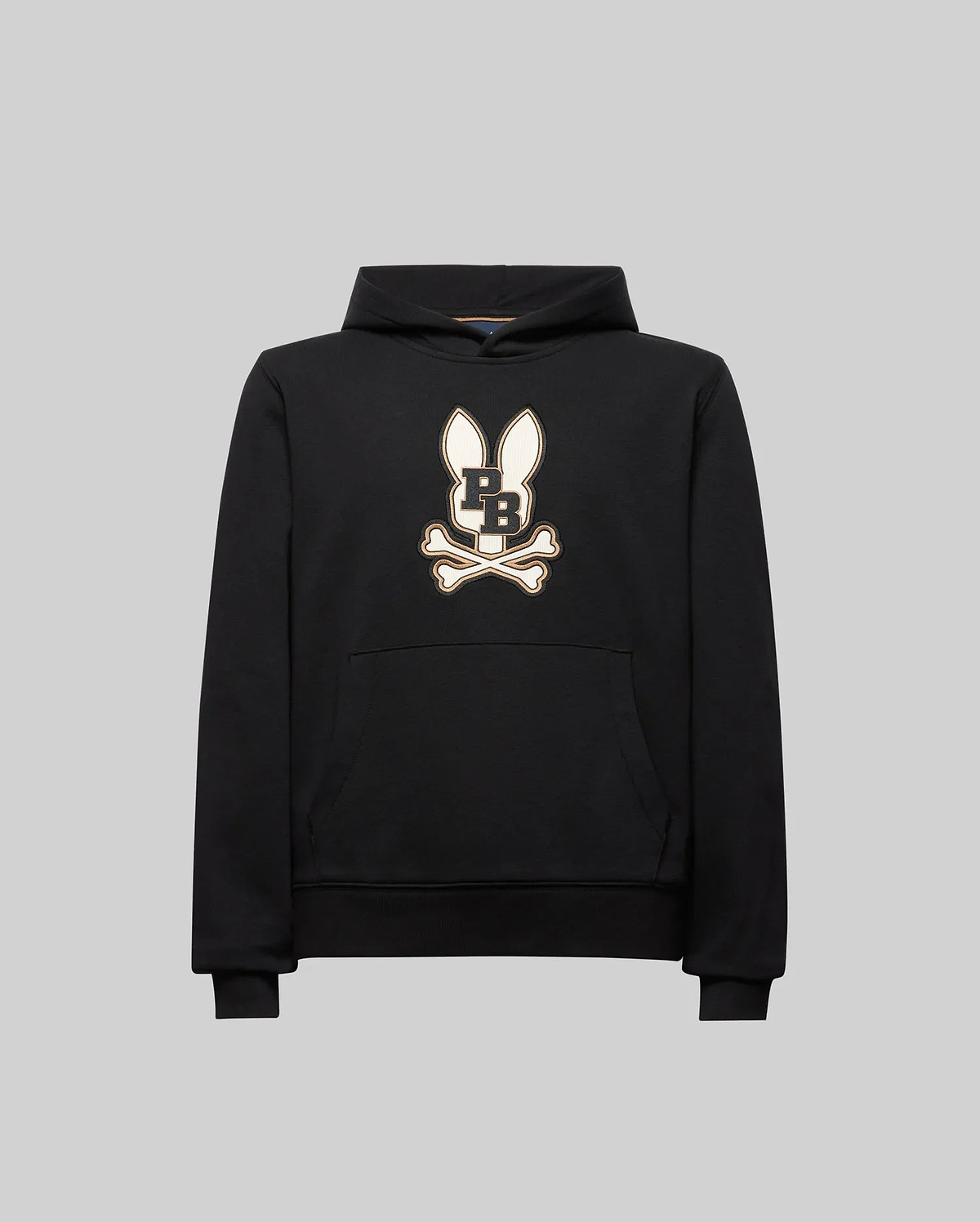 The Psycho Bunny KIDS WADE CORD PATCH HOODIE (KT0500031) is a black athletic hoodie in a premium cotton blend, featuring an embroidered long-eared Bunny patch with "PB" on the chest, shown on a plain gray background.