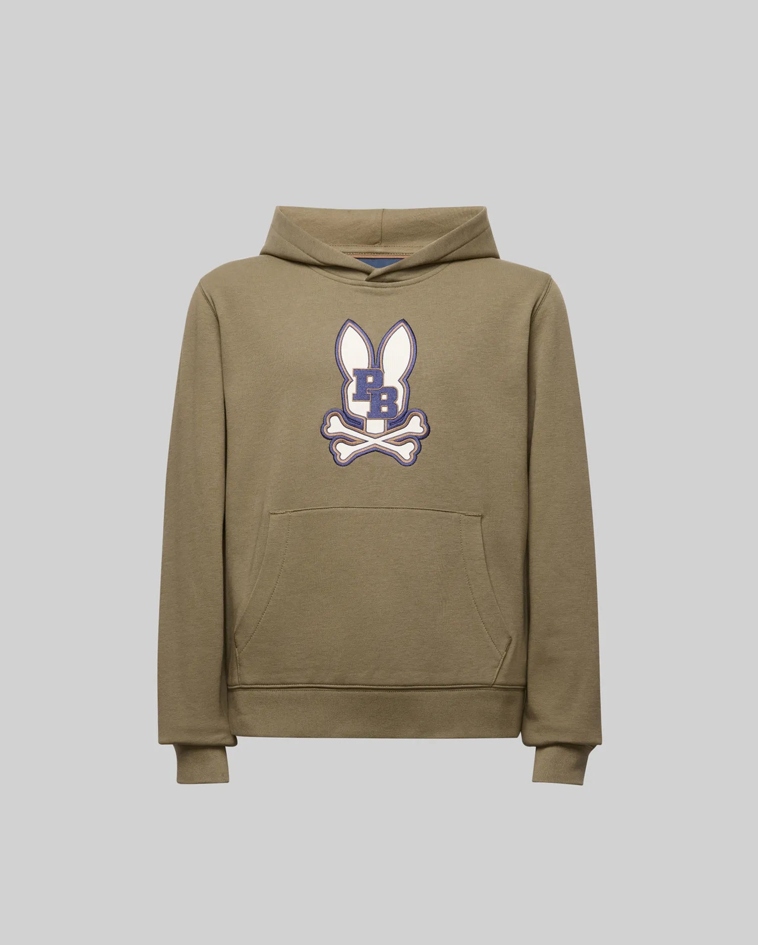The Psycho Bunny KIDS WADE CORD PATCH HOODIE (KT0500031) is a khaki pullover made from premium cotton blend, featuring a front pocket and a cartoon bunny head with upright ears, crossed bones, and a dark blue "B" on its face.