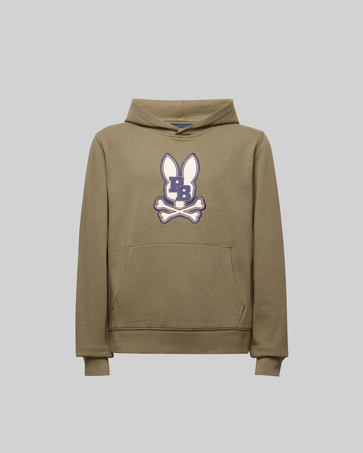 The Psycho Bunny KIDS WADE CORD PATCH HOODIE (KT0500031) is a khaki pullover made from premium cotton blend, featuring a front pocket and a cartoon bunny head with upright ears, crossed bones, and a dark blue "B" on its face.