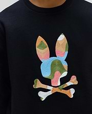 Black Kids Ara Crew sweatshirt featuring a large, central embroidered Psycho Bunny skull logo in a vibrant patchwork of blue, green, pink, orange, and white on smooth jersey fabric.