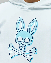 White Kids Dax Oversized Hoodie featuring a large central light blue Psycho Bunny skull and crossbones graphic with a dark blue outline and shadow effect, made from smooth knit fabric.