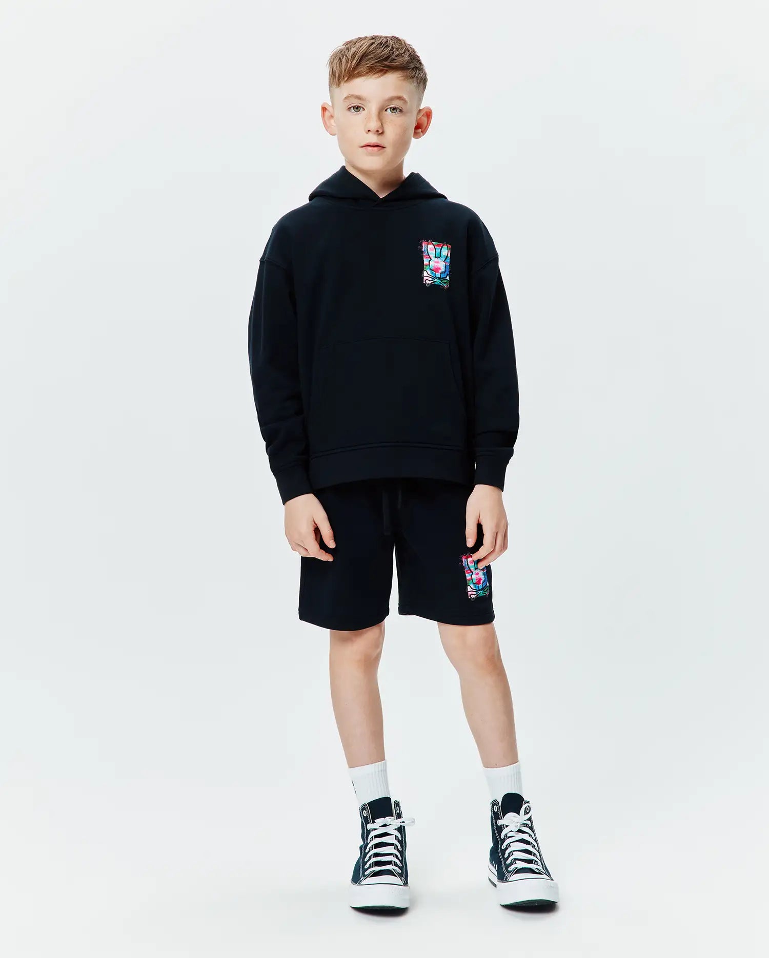 Black Kids Isaac Print Hoodie and matching shorts, relaxed fit french terry, featuring a small colorful Psycho Bunny skull logo print on the left chest and left thigh.