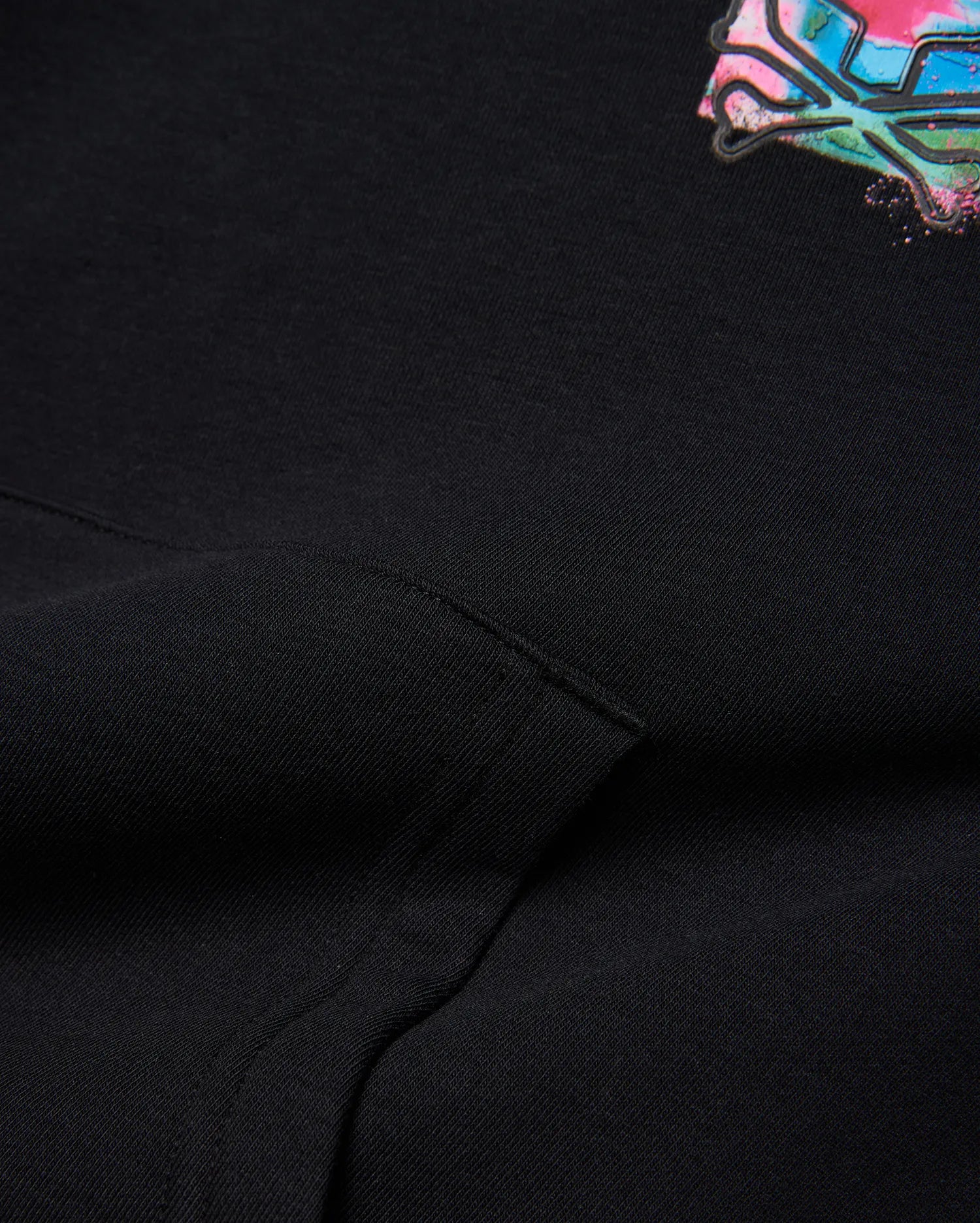 Kids Isaac Print Hoodie, black soft french terry with a relaxed fit, featuring a vibrant, splattered Psycho Bunny skull logo in pink, blue, and green on the chest.