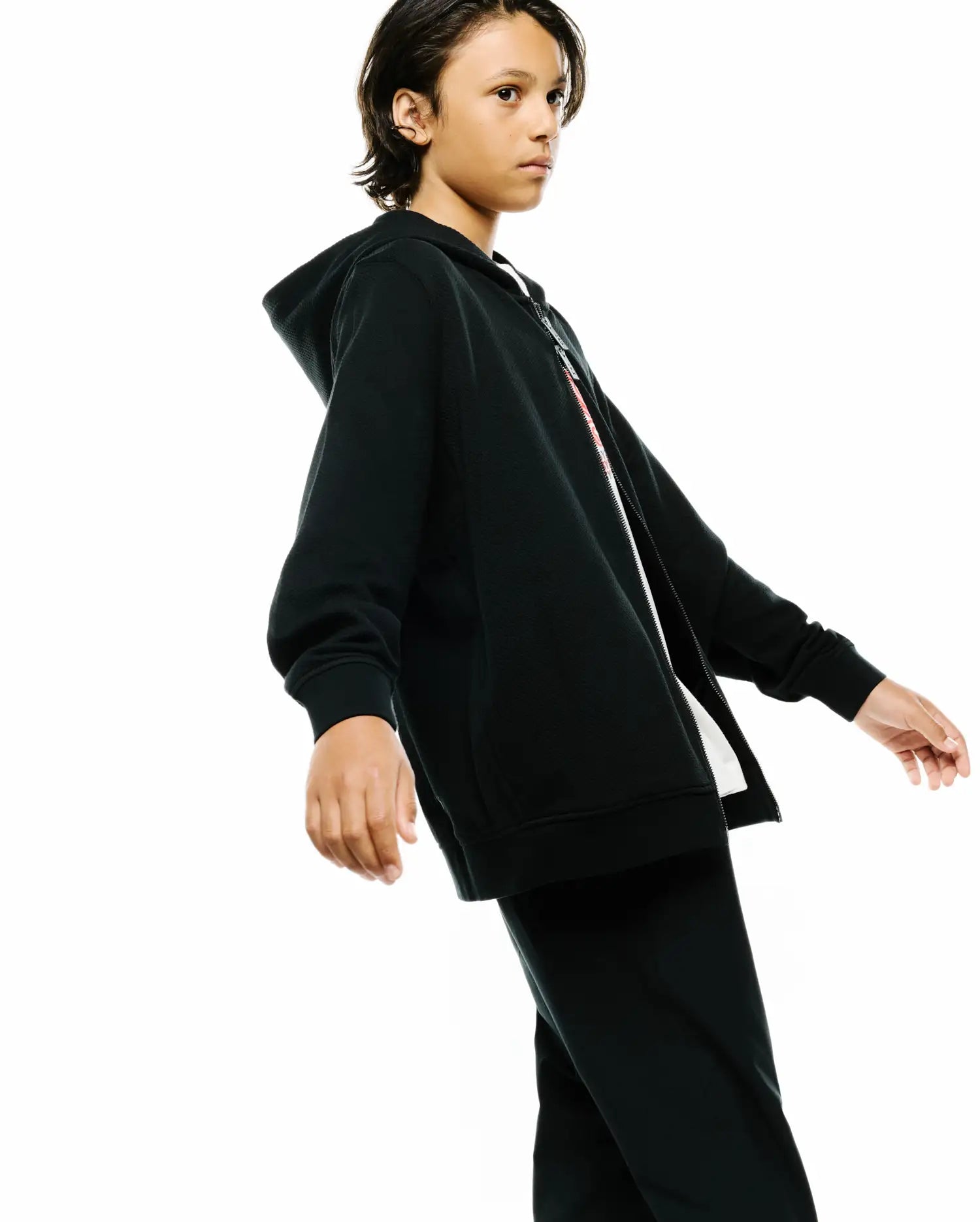 Kids Marc Textured Full Zip Hoodie in black, featuring a textured knit fabric, a full white zipper with a subtle red accent stripe, and a relaxed fit with ribbed cuffs and hem.