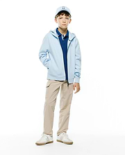 Kids Marc Textured Full Zip Hoodie in light blue, with textured fabric and an embroidered Psycho Bunny chest logo. Layered over a navy pique polo, beige cargo pants, and a light blue Psycho Bunny cap.