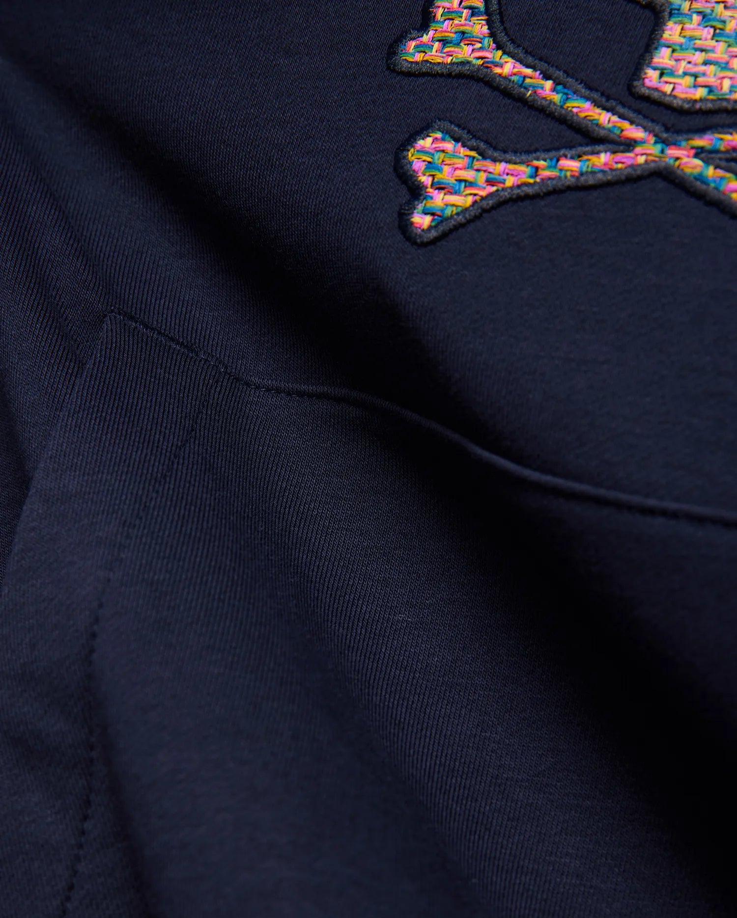 Kids Darcy Hoodie in deep navy blue, featuring a large, embroidered multicolored woven Psycho Bunny skull and crossbones logo and a front kangaroo pocket detail on soft knit fabric.