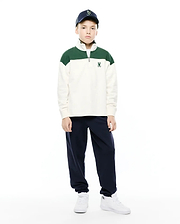 Kids Gabe French Terry 1/4 Zip, a relaxed fit cream pullover with green color-block shoulders, soft French terry fabric, a silver 1/4 zip, and a small embroidered Psycho Bunny skull logo on the left chest.