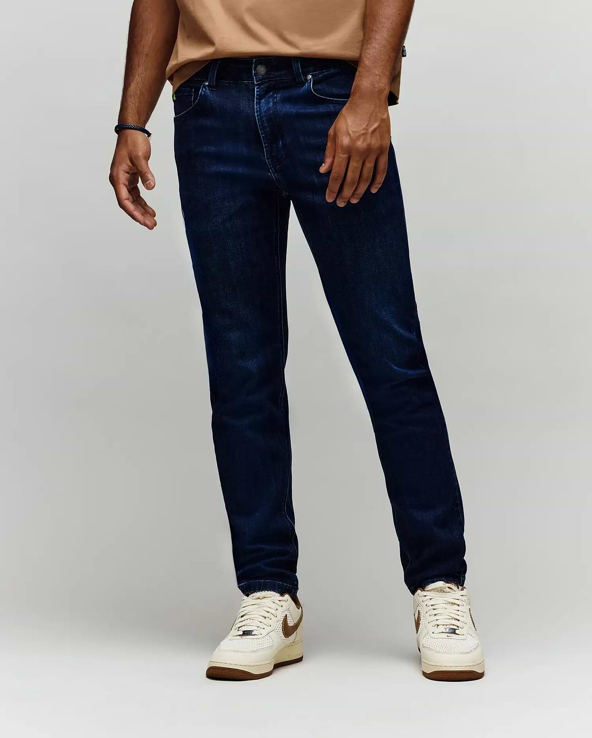 Mens Emerson Denim Pant, dark indigo slim fit denim jeans with classic five-pocket styling, subtle whiskering, and a small green Psycho Bunny logo tag on the coin pocket.