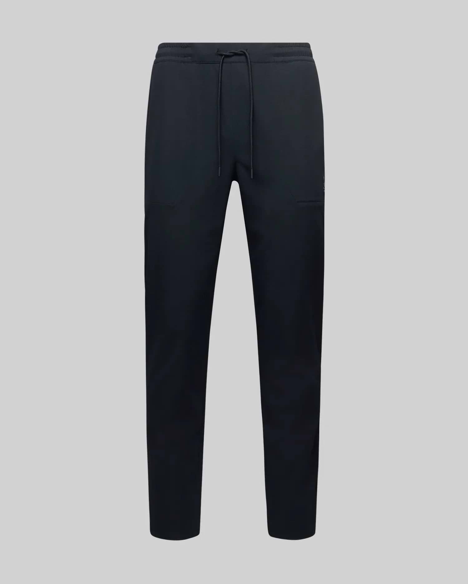 The MENS BEN TECH JOGGER PULL ON - MB0600013 by Psycho Bunny, made from polyester spandex fabric with an elastic waistband, drawstring, and side pockets, is shown against a plain light grey background.
