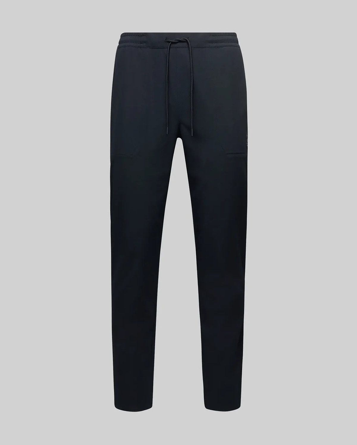 The MENS BEN TECH JOGGER PULL ON - MB0600013 by Psycho Bunny, made from polyester spandex fabric with an elastic waistband, drawstring, and side pockets, is shown against a plain light grey background.