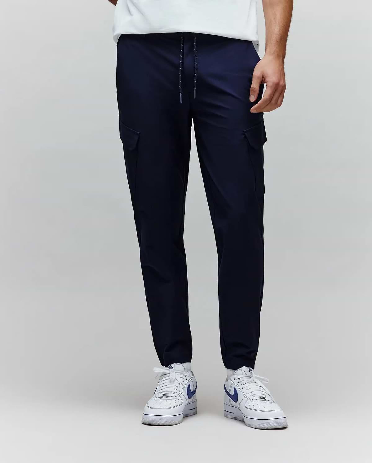 Mens Luka Cargo Pant in navy, featuring a relaxed tapered fit, smooth fabric, side cargo pockets, and a speckled drawstring waist. (1)