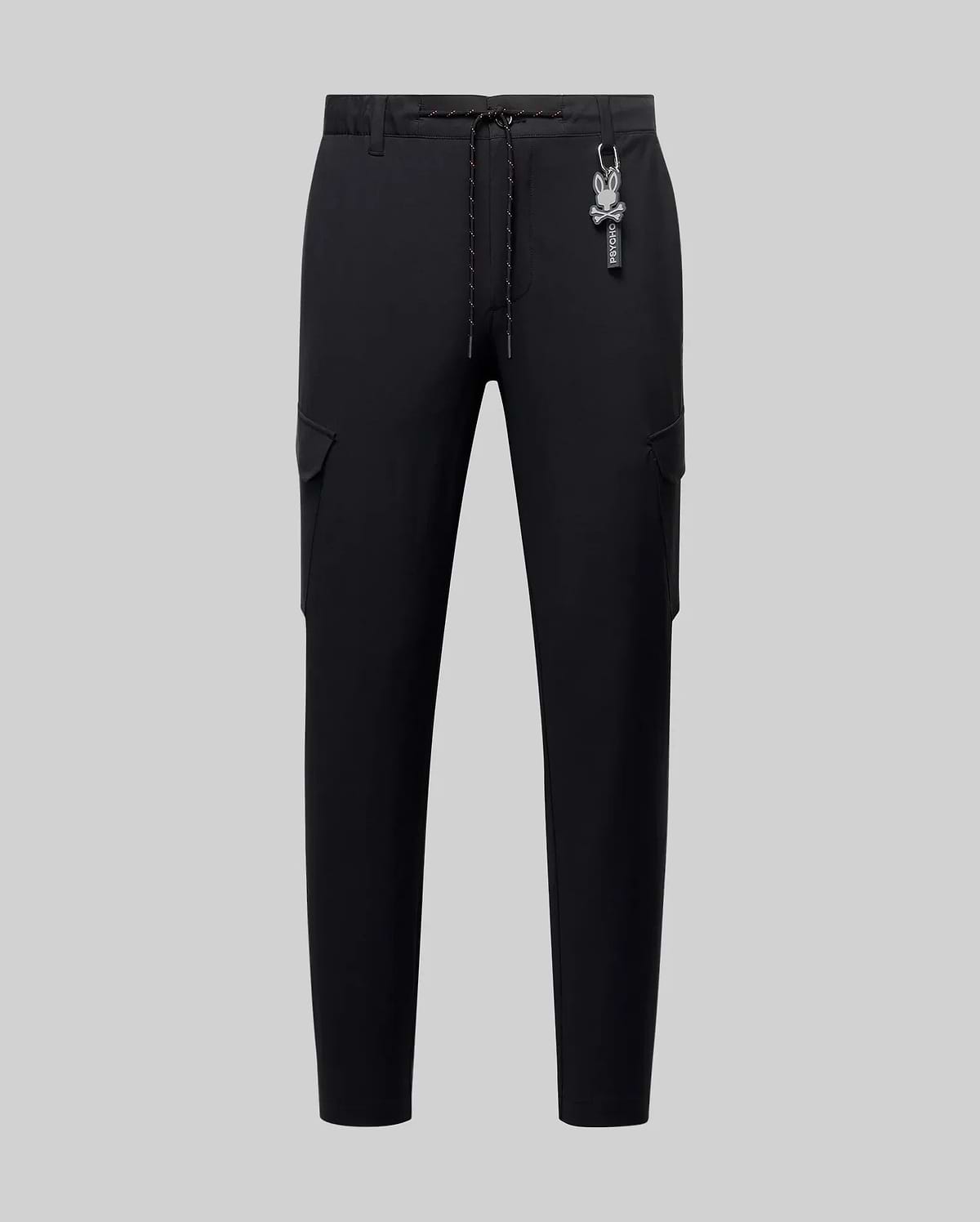 Mens Luka Cargo Pant, black, featuring a slim tapered fit, smooth fabric, side cargo pockets, an orange-flecked drawstring, and a white Psycho Bunny skull logo keychain. (5)