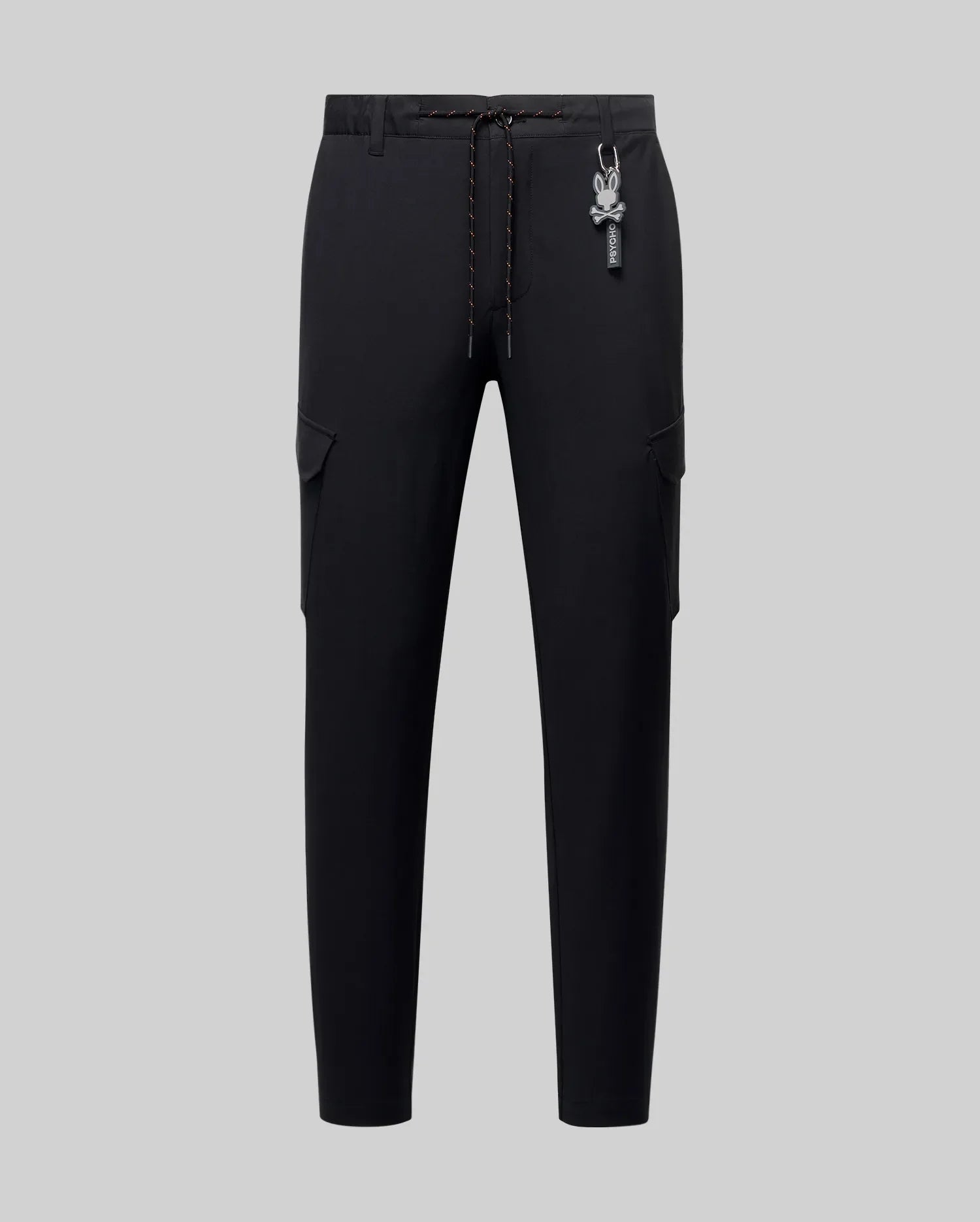 Mens Luka Cargo Pant, black, featuring a slim tapered fit, smooth fabric, side cargo pockets, an orange-flecked drawstring, and a white Psycho Bunny skull logo keychain. (5)