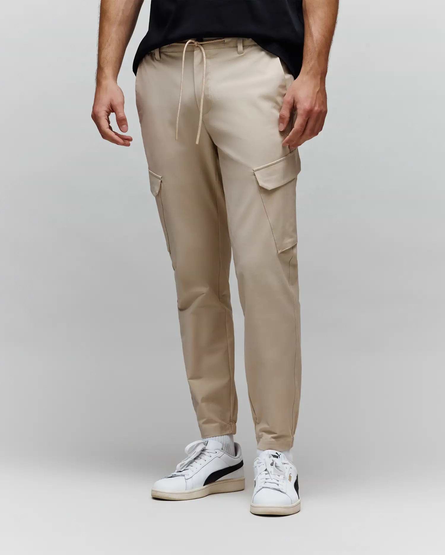 Mens Luka Cargo Pant in light beige, a relaxed tapered fit with smooth fabric, featuring a drawstring waist and functional flap cargo pockets.