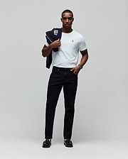 White jersey t-shirt with small embroidered Psycho Bunny logo on left chest, paired with black Mens Emerson Slim Fit Denim Pant and a black track jacket with large white Psycho Bunny graphic over the shoulder. (5)