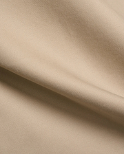 Mens Aidan Chino Pant in a warm khaki beige, featuring a refined, durable twill weave fabric with visible diagonal lines and a smooth, soft texture, draped in gentle folds.