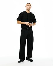 Black relaxed-fit jersey t-shirt featuring a subtle tonal Psycho Bunny skull logo on the left chest, paired with Men's Wayde Wide-Leg Pleated Pants in a smooth black fabric. (1)