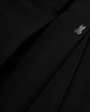 Men's Wayde Wide-Leg Pleated Pants in black, featuring a subtle fabric texture, wide-leg fit, and a small metallic silver Psycho Bunny skull logo near the waistband. (6)