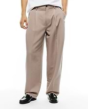 Men's Wayde Wide-Leg Pleated Pants in taupe, featuring a relaxed wide-leg fit, smooth woven fabric, front pleats, a black button closure, and a small embroidered Psycho Bunny skull logo near the right front pocket. (2)