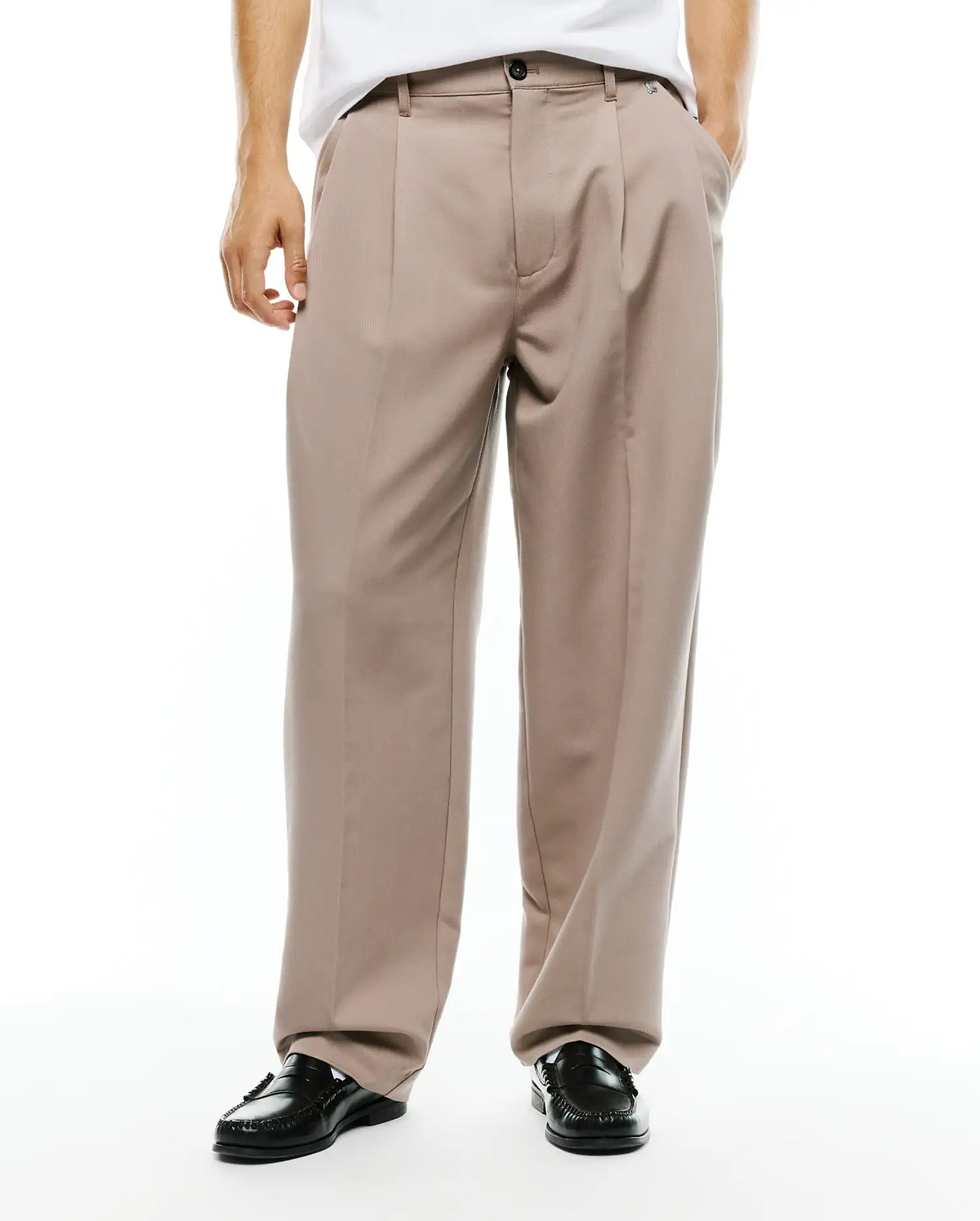 Men's Wayde Wide-Leg Pleated Pants in taupe, featuring a relaxed wide-leg fit, smooth woven fabric, front pleats, a black button closure, and a small embroidered Psycho Bunny skull logo near the right front pocket. (2)