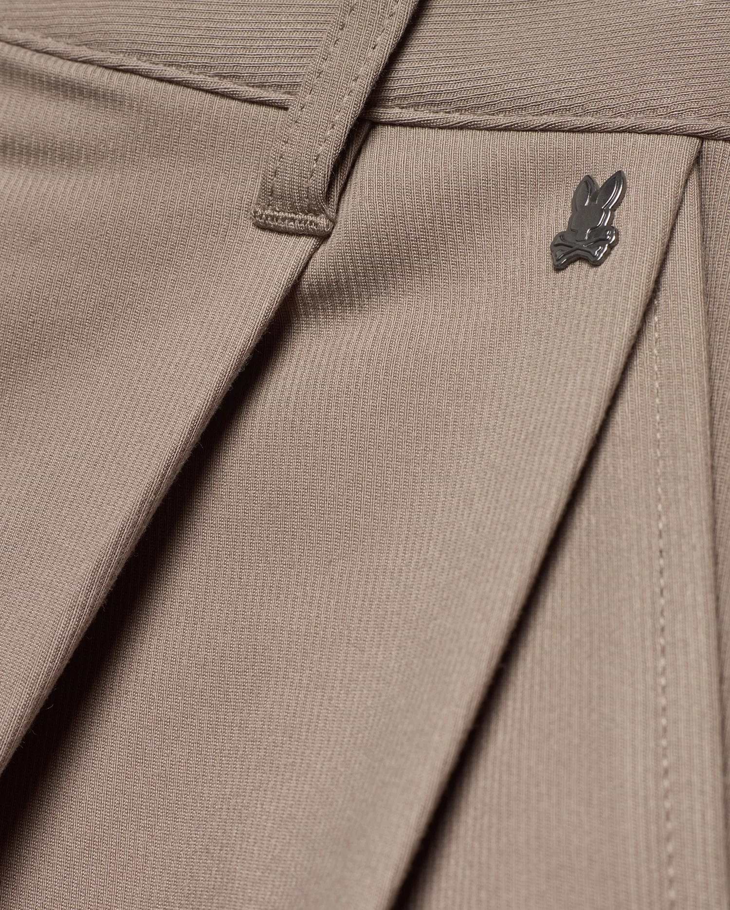 MEN'S WAYDE WIDE-LEG PLEATED PANTS in taupe, featuring a subtle ribbed knit texture, front pleats, and a small dark metal Psycho Bunny skull logo near the waistband. (6)