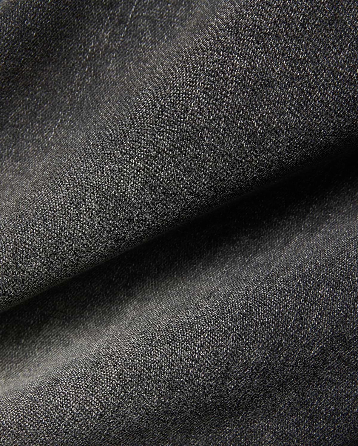 Mens Emerson Denim Pant featuring a dark charcoal grey denim fabric with a visible twill weave and subtle light flecks, creating a textured, washed appearance. (6)