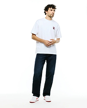 White relaxed fit jersey t-shirt with a small pink-outlined embroidered Psycho Bunny skull logo on the left chest, paired with dark indigo Men's Beck Oversized Denim Pants. (4)